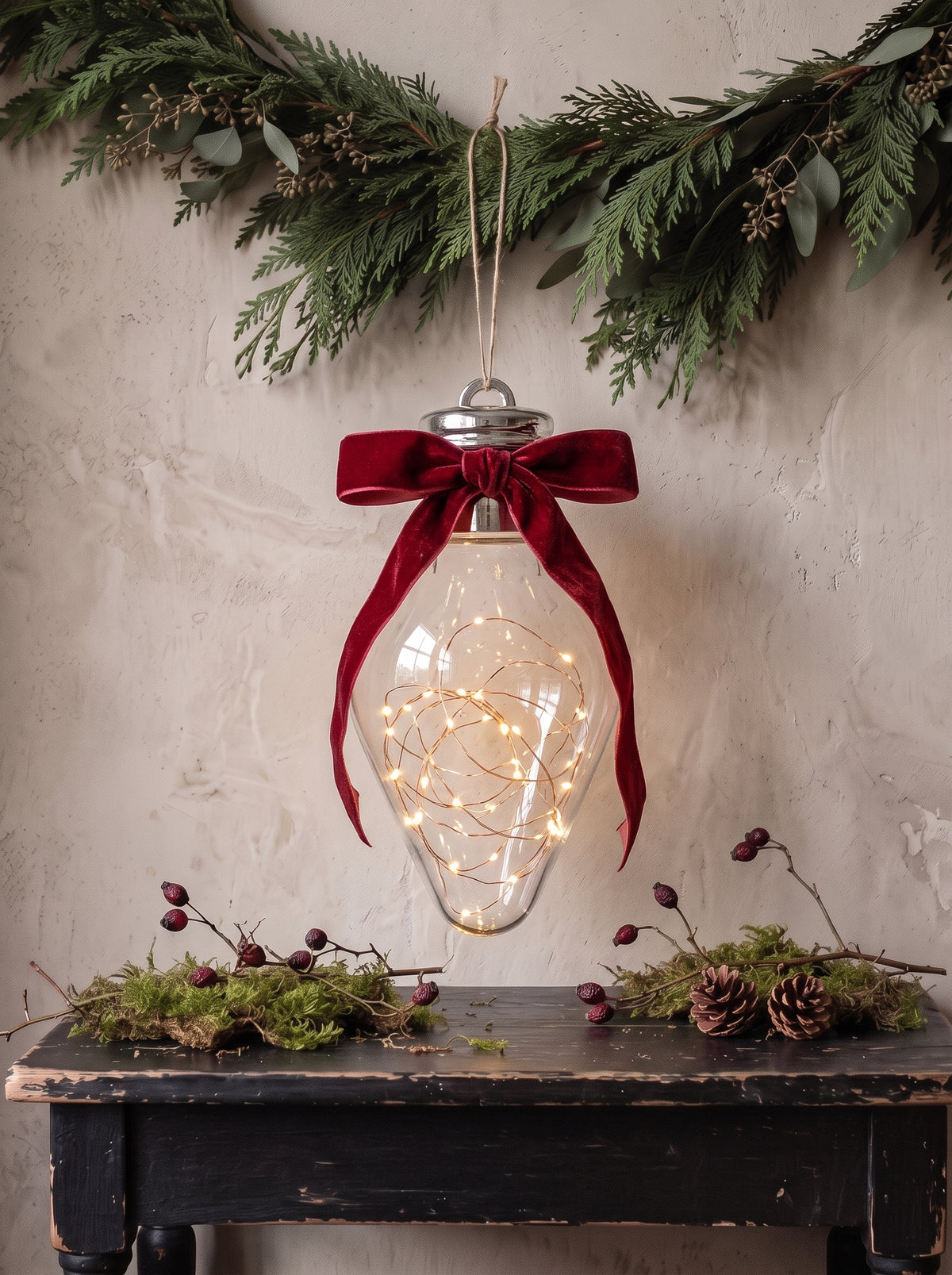 Large fillable Christmas ornament with included warm white fairy lights and a red velvet bow